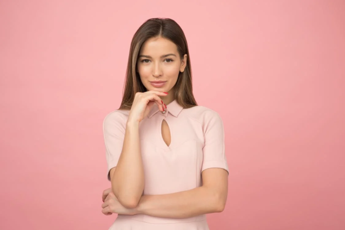 A woman in a baby-pink outfit