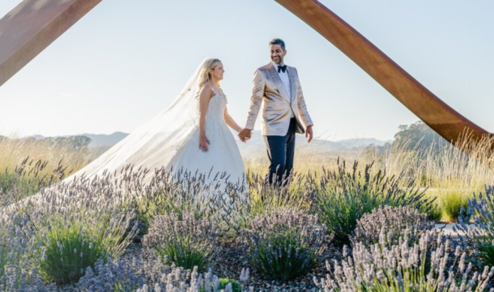 A bride and groom roaming hand in hand